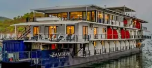 The Zambezi Trader houseboat by the shores of Lake Kariba, the lights have been switched on in preparation for the night